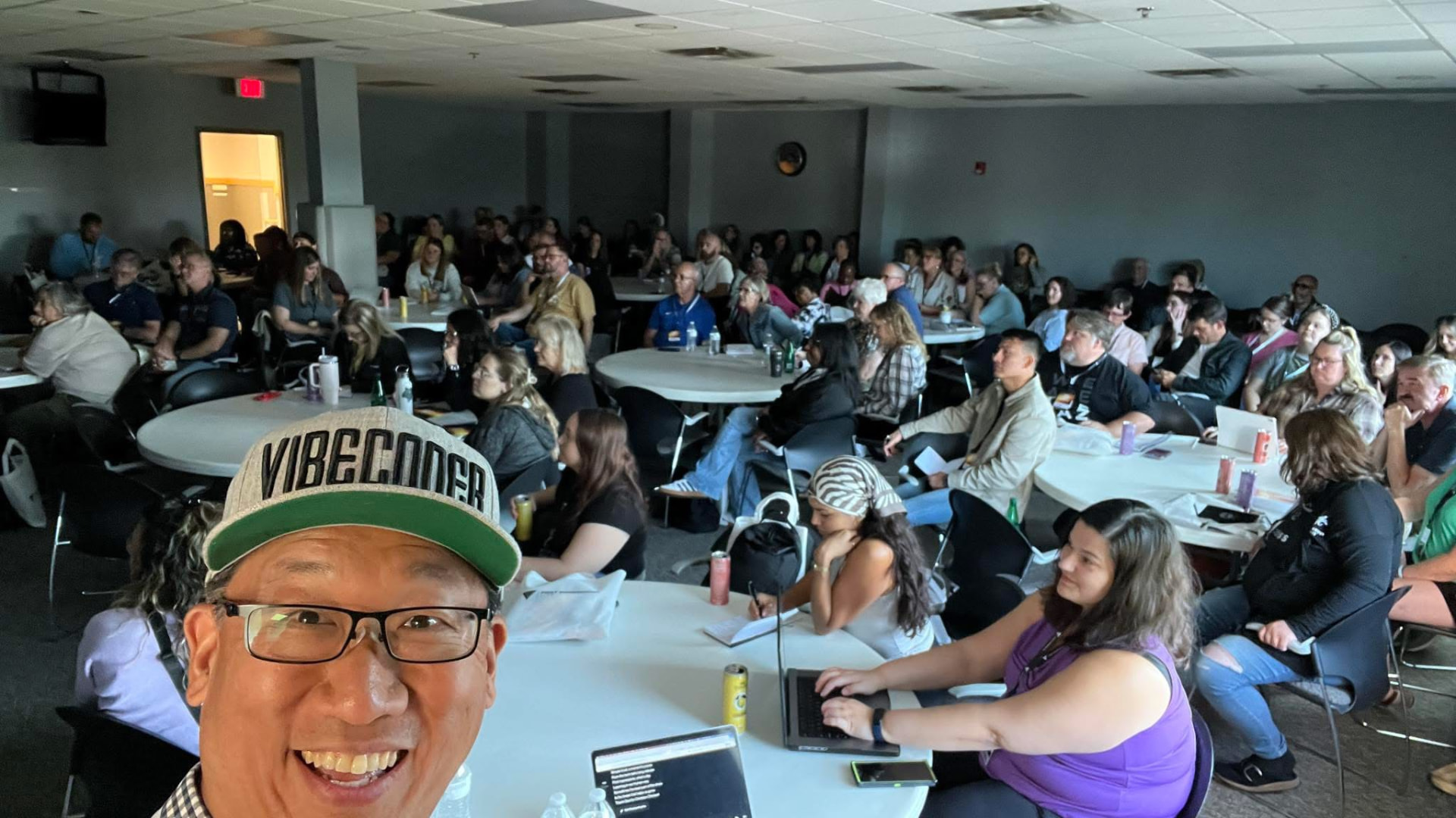 Last year's pre-conference workshop room full of people at round tables