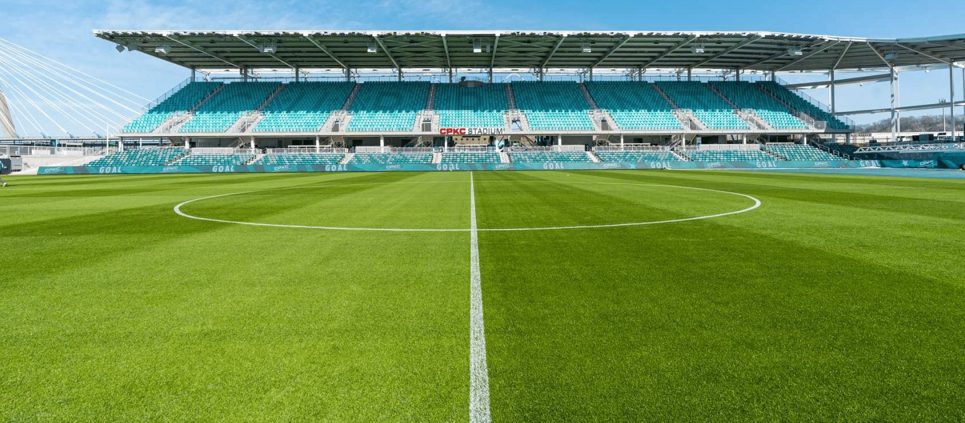 CPKC Stadium, home of KC Current, with the teal stands and pitch under a blue sky